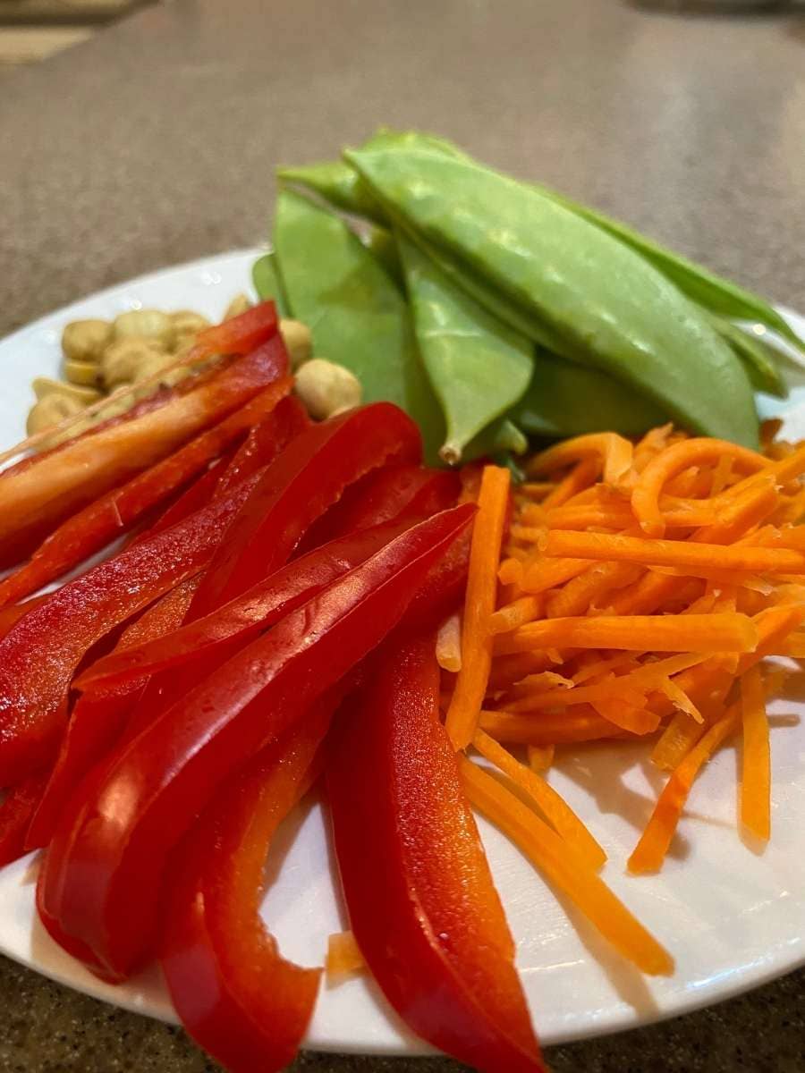 Bell peppers, carrots, snow peas, and roasted peanuts are excellent toppings.